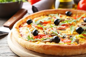 Fresh tasty pizza on grey wooden background