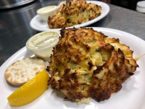 A Maryland crab cake served with sauce